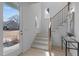Bright entryway featuring a staircase with black metal railings and modern design elements at 505 Colleton Rd, Raleigh, NC 27610