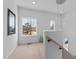Bright foyer featuring hardwood floors, large windows, and a staircase at 505 Colleton Rd, Raleigh, NC 27610