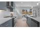 Contemporary kitchen featuring blue cabinetry, white countertops, and a view of the outdoor patio at 505 Colleton Rd, Raleigh, NC 27610