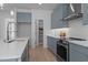Bright kitchen featuring sleek countertops, a pantry, and stainless steel appliances at 505 Colleton Rd, Raleigh, NC 27610