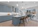 Modern kitchen with stainless steel appliances, island with seating, and adjacent dining area at 505 Colleton Rd, Raleigh, NC 27610