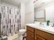 Functional bathroom features a shower with patterned curtain and a vanity with a sink at 5264 Patuxent Dr, Raleigh, NC 27616