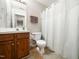 Bathroom featuring a toilet, shower with curtain, and a sink vanity at 5264 Patuxent Dr, Raleigh, NC 27616