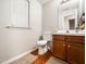 Well-lit bathroom with a single sink vanity and classic finishes throughout at 5264 Patuxent Dr, Raleigh, NC 27616