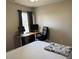 Bedroom with a bed, a desk with two monitors, and an office chair by the window at 5264 Patuxent Dr, Raleigh, NC 27616