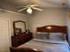 Cozy bedroom featuring a ceiling fan, dresser, and ample natural light from the window at 5264 Patuxent Dr, Raleigh, NC 27616