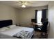 Bedroom with a bed, a desk with two monitors, and an office chair by the window at 5264 Patuxent Dr, Raleigh, NC 27616