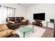 Relaxing living room with plush sofa, glass table, and a large flat-screen television at 5264 Patuxent Dr, Raleigh, NC 27616