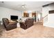 Bright living room featuring wood-look floors, modern furnishings, and an open design to the kitchen at 5264 Patuxent Dr, Raleigh, NC 27616