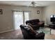 Inviting living room with a comfortable leather sofa and sliding glass door to the backyard at 5264 Patuxent Dr, Raleigh, NC 27616