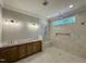 Modern bathroom featuring a double vanity, stone counters, tiled shower, and a window at 55 Cherry Bark Dr, Youngsville, NC 27596