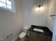 Bathroom with board and batten accent wall and a vanity with black countertop at 55 Cherry Bark Dr, Youngsville, NC 27596