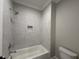 Bathroom featuring a bathtub with gray tiled surround and a built-in niche at 55 Cherry Bark Dr, Youngsville, NC 27596