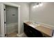 Well-lit bathroom featuring tile flooring, modern lighting, and a shower over tub at 55 Cherry Bark Dr, Youngsville, NC 27596