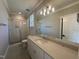 Bright bathroom featuring a glass-enclosed shower and white vanity with a large mirror at 55 Cherry Bark Dr, Youngsville, NC 27596