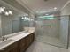 Luxurious bathroom with double vanity, frameless glass shower, and modern fixtures at 55 Cherry Bark Dr, Youngsville, NC 27596