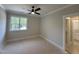 Bright bedroom with a ceiling fan and a large window overlooking a green exterior at 55 Cherry Bark Dr, Youngsville, NC 27596