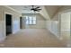 Bright bedroom featuring paneled walls, natural light, and access to other rooms at 55 Cherry Bark Dr, Youngsville, NC 27596