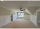 Unfinished bedroom with ceiling fan, wainscoting, and bright windows at 55 Cherry Bark Dr, Youngsville, NC 27596