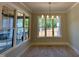 Bright dining room with large windows, neutral walls, hardwood floors, and modern chandelier at 55 Cherry Bark Dr, Youngsville, NC 27596