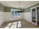 Dining room featuring hardwood floors, modern lighting, with a large window allowing ample natural light at 55 Cherry Bark Dr, Youngsville, NC 27596