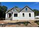 Charming home with a combination of painted brick and vinyl siding, set against a backdrop of lush greenery at 55 Cherry Bark Dr, Youngsville, NC 27596