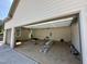Spacious garage featuring an automatic door, ladder, and ample room for parking and storage; well-lit and functional at 55 Cherry Bark Dr, Youngsville, NC 27596