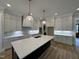 Spacious kitchen with custom white cabinets, large island, and stylish pendant lighting at 55 Cherry Bark Dr, Youngsville, NC 27596