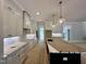 Spacious kitchen with gray cabinets, white countertops, an island, and gleaming wood floors at 55 Cherry Bark Dr, Youngsville, NC 27596
