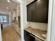 Kitchen featuring black and white cabinets, light countertops, and gleaming wood floors at 55 Cherry Bark Dr, Youngsville, NC 27596