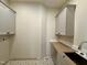 Laundry room featuring stylish tile flooring, modern fixtures, and ample cabinet space at 55 Cherry Bark Dr, Youngsville, NC 27596