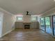 Spacious living room featuring a cozy fireplace, custom built-ins, and access to outdoor space at 55 Cherry Bark Dr, Youngsville, NC 27596
