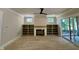 Open-concept living room with a fireplace, built-in shelving, and sliding glass doors at 55 Cherry Bark Dr, Youngsville, NC 27596