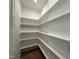 Walk-in pantry with white shelving and wood floors, ideal for organized storage at 55 Cherry Bark Dr, Youngsville, NC 27596
