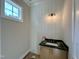 Compact powder room featuring a vanity with modern fixtures and stylish wall accents at 55 Cherry Bark Dr, Youngsville, NC 27596