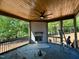 Under-construction screened porch featuring a ceiling fan, fireplace, and wooded views, offering an inviting outdoor space at 55 Cherry Bark Dr, Youngsville, NC 27596