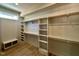 Spacious walk-in closet with built-in shelving, wood accents, and a window at 55 Cherry Bark Dr, Youngsville, NC 27596