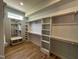 Well-organized walk-in closet with custom shelving and ample storage space at 55 Cherry Bark Dr, Youngsville, NC 27596