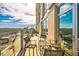 Spacious balcony with a seating area, glass railing, and views of the city skyline at 601 W Rosemary St # 403, Chapel Hill, NC 27516