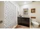 Well-lit bathroom featuring a shower with polka dot curtain, vanity with granite countertop, and toilet at 601 W Rosemary St # 403, Chapel Hill, NC 27516