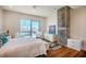 Comfortable bedroom with wood floors, stylish decor, and a window with natural light at 601 W Rosemary St # 403, Chapel Hill, NC 27516