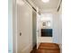 Hallway view into bathroom with stylish doors, hardwood floors, and modern decor at 601 W Rosemary St # 403, Chapel Hill, NC 27516