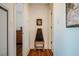 Hallway with a unique cabinet on decorative legs, hardwood floors, and artwork on the walls at 601 W Rosemary St # 403, Chapel Hill, NC 27516