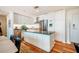 Clean, modern kitchen features an island with a stainless steel refrigerator and white cabinets at 601 W Rosemary St # 403, Chapel Hill, NC 27516