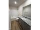 Well-lit bathroom featuring a granite vanity and a shower over tub at 73 Phil Jack Rd, Dunn, NC 28334