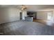 Open concept living room showcasing gray cabinets, carpet, ceiling fan, and hardwood floors at 73 Phil Jack Rd, Dunn, NC 28334