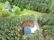 An aerial shot highlighting the home's private setting amongst mature trees in a quiet neighborhood at 749 Bowden Rd, Chapel Hill, NC 27516