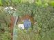 Aerial view showcasing a home surrounded by lush trees and a large driveway at 749 Bowden Rd, Chapel Hill, NC 27516