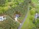 An aerial perspective showing the home's location near a road, surrounded by dense trees at 749 Bowden Rd, Chapel Hill, NC 27516