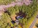 Aerial view of a secluded home surrounded by tall trees, showcasing its driveway and location at 749 Bowden Rd, Chapel Hill, NC 27516